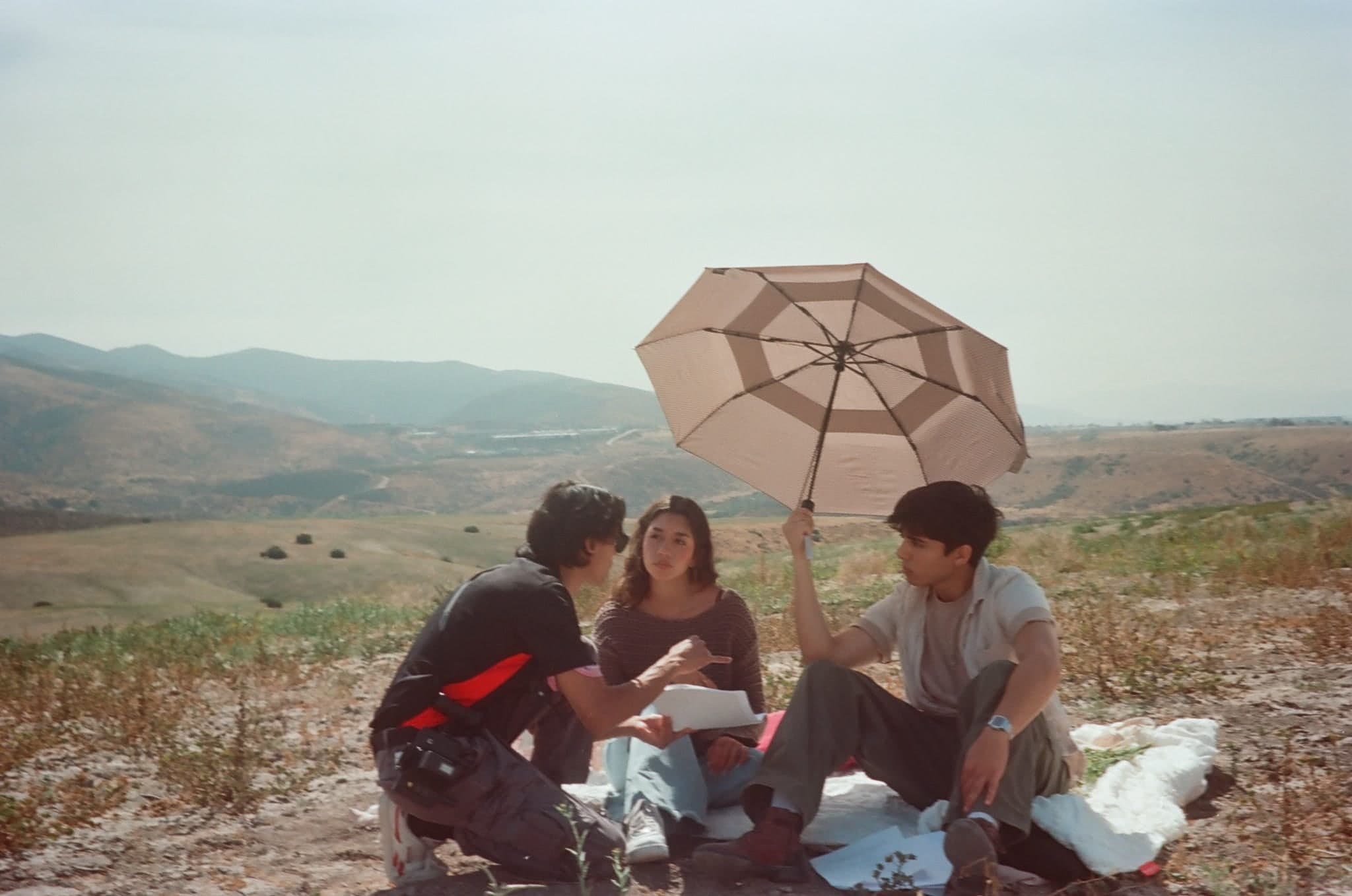 Film photograph of a director giving notes on a hillside