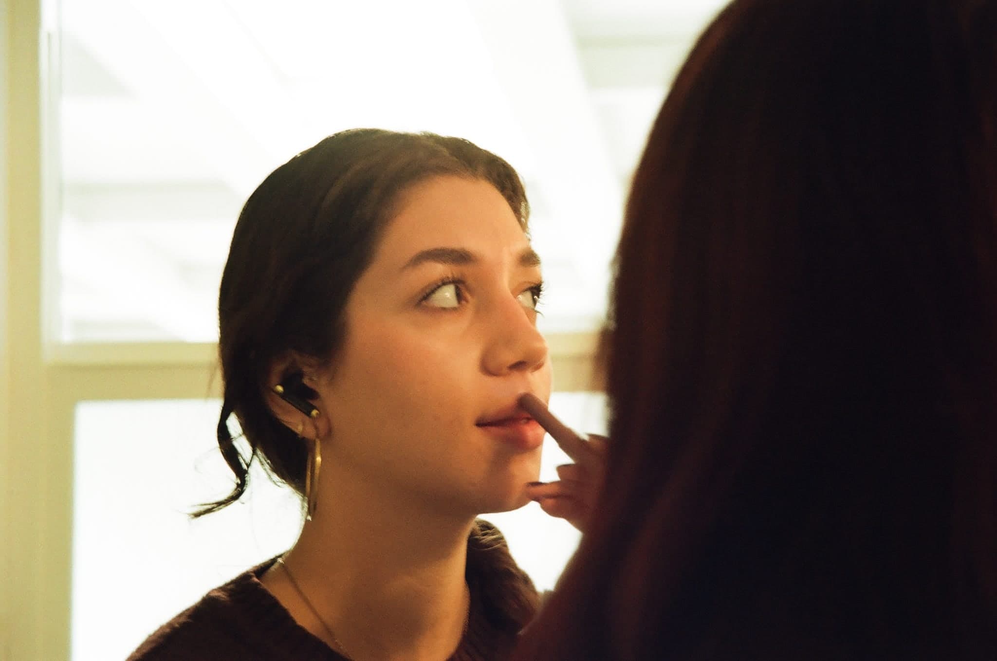Film photograph of a makeup touch-up before a take