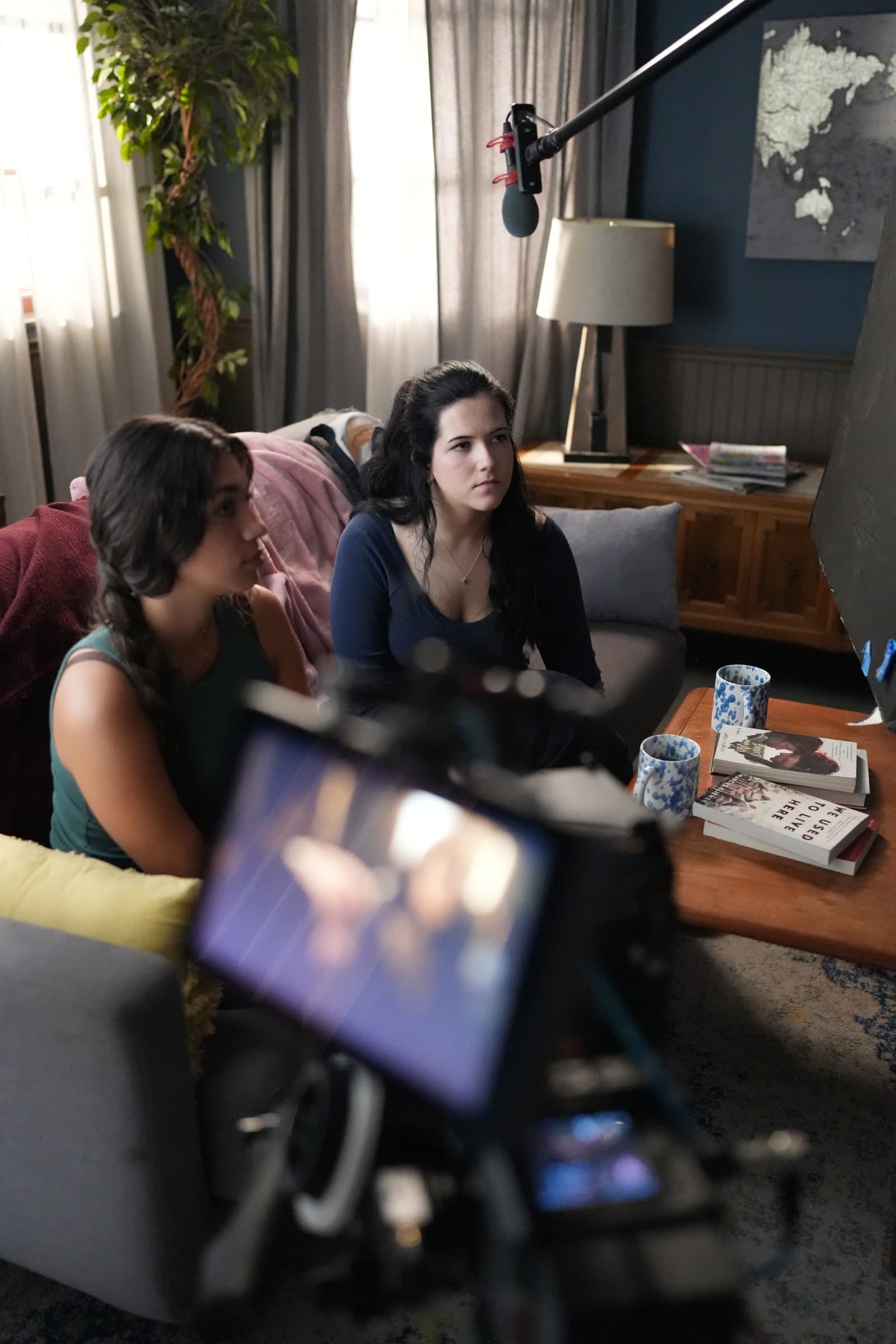 Living-room set with Emily Loaiza and a scene partner on the couch
