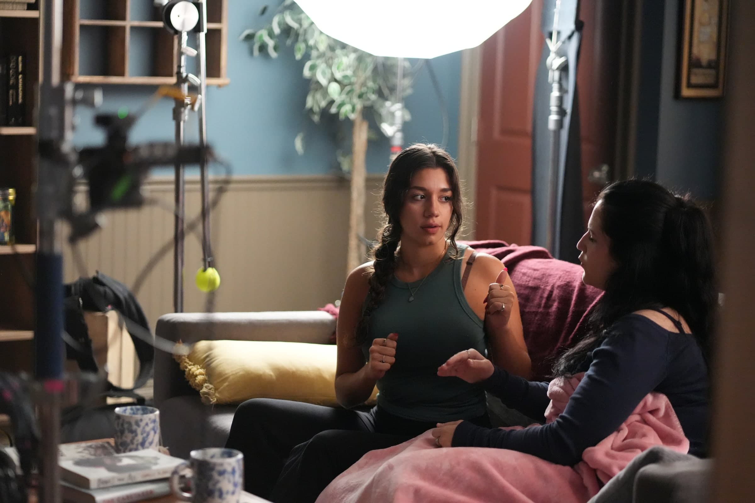 Emily Loaiza mid-scene under a large lantern light