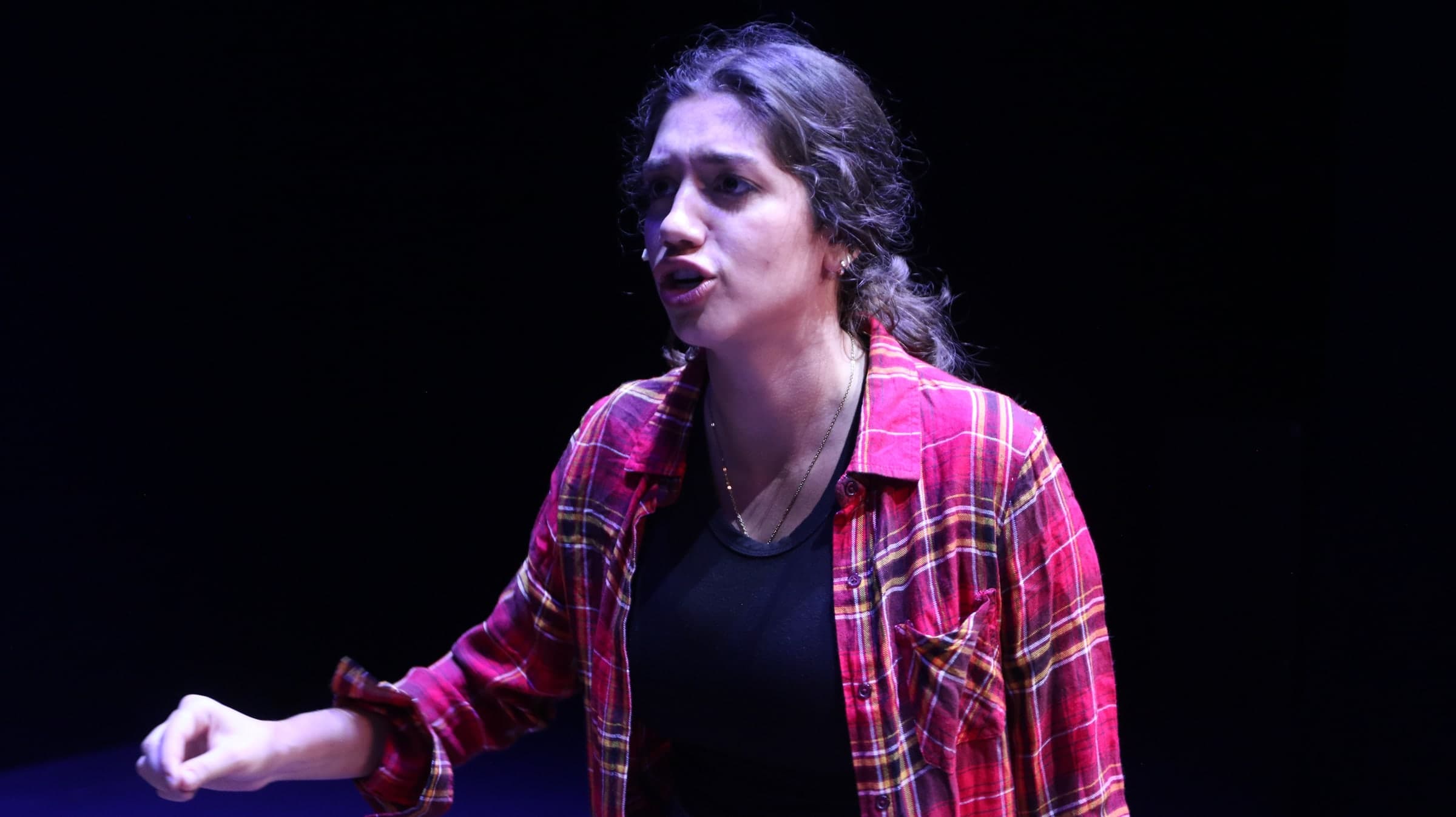 Emily Loaiza delivering an intense line on stage