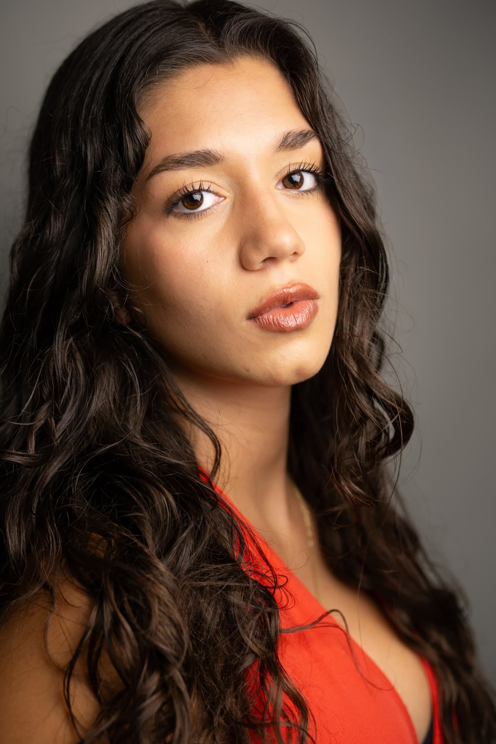 Three-quarter headshot of Emily Loaiza against a grey backdrop